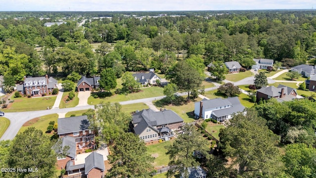 birds eye view of property featuring a residential view and a forest view