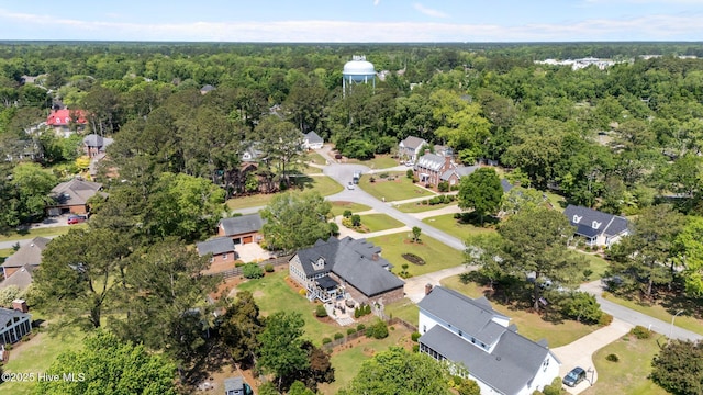 drone / aerial view featuring a residential view and a forest view