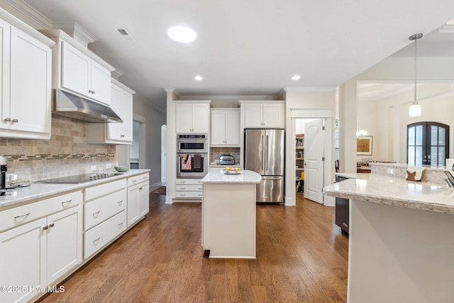 kitchen featuring backsplash, ornamental molding, appliances with stainless steel finishes, and under cabinet range hood