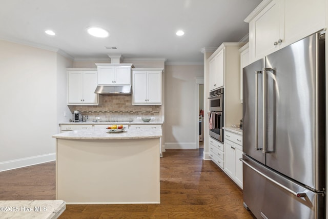 kitchen with under cabinet range hood, stainless steel appliances, tasteful backsplash, and ornamental molding