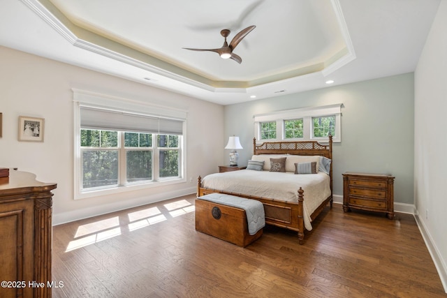 bedroom with a ceiling fan, recessed lighting, baseboards, dark wood-type flooring, and a raised ceiling