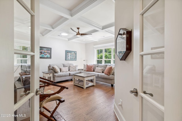 living room with ceiling fan, crown molding, beam ceiling, and coffered ceiling