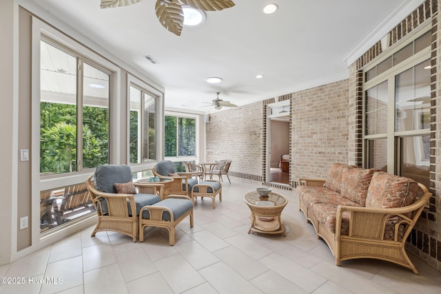 sunroom / solarium featuring brick wall, an outdoor hangout area, a ceiling fan, and recessed lighting