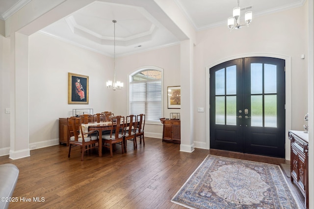 foyer featuring french doors, baseboards, dark wood-style flooring, a chandelier, and crown molding
