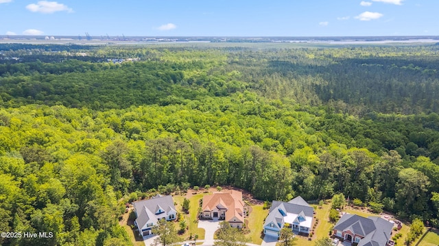 drone / aerial view with a wooded view and a residential view