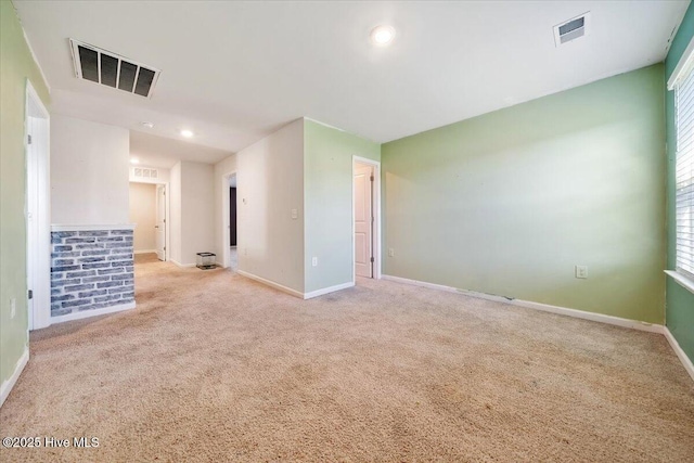 spare room featuring visible vents, carpet flooring, and baseboards