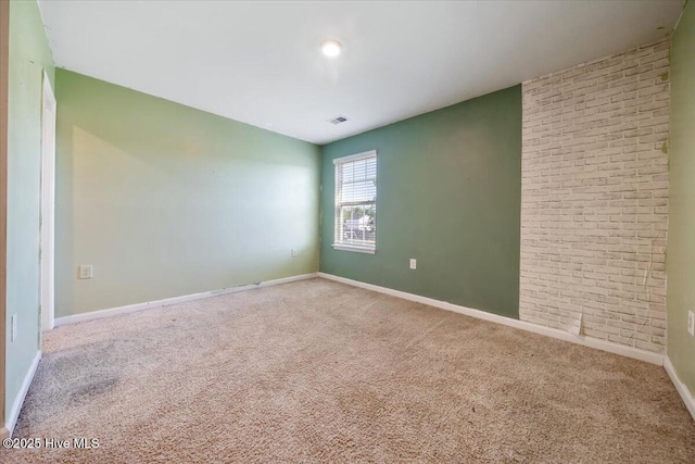 carpeted empty room with baseboards and visible vents