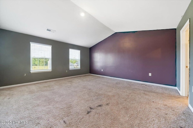 interior space featuring baseboards, carpet, and lofted ceiling
