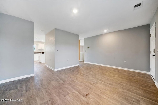 unfurnished living room featuring recessed lighting, baseboards, visible vents, and light wood-style flooring
