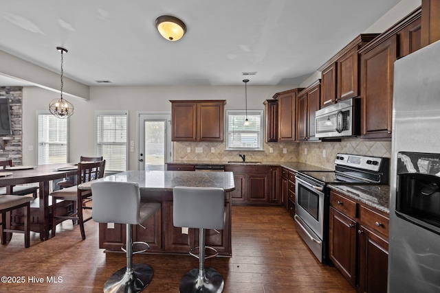 220 Rustic Field Dr, Goldsboro, NC 27530 - kitchen featuring appliances with stainless steel finishes, a sink, decorative backsplash, and dark stone counters