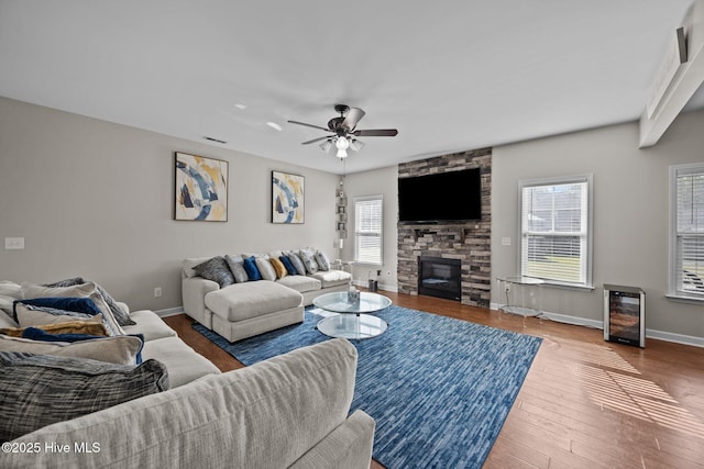 220 Rustic Field Dr, Goldsboro, NC 27530 - living area featuring beverage cooler, a fireplace, baseboards, and plenty of natural light