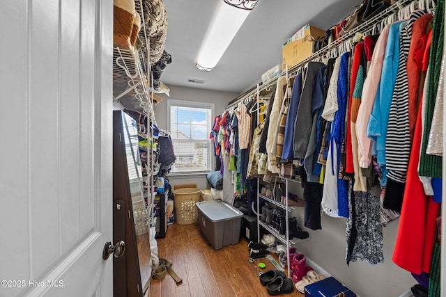 walk in closet with visible vents and wood finished floors