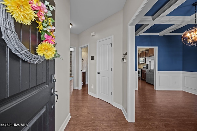 220 Rustic Field Dr, Goldsboro, NC 27530 - entrance foyer featuring a chandelier, dark wood-type flooring, beam ceiling, coffered ceiling, and ornamental molding
