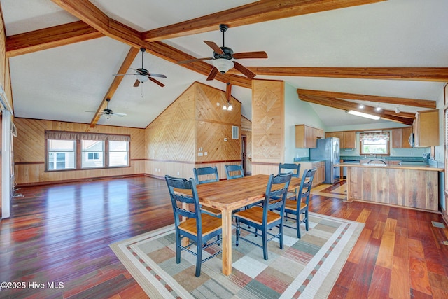 dining room with wood walls, wood finished floors, and a ceiling fan