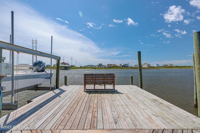 dock area with boat lift and a water view