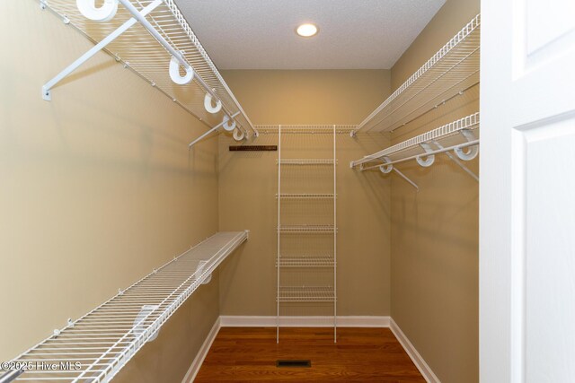 27 Mcmichael Dr, Pinehurst, NC 28374 - walk in closet featuring visible vents and wood finished floors