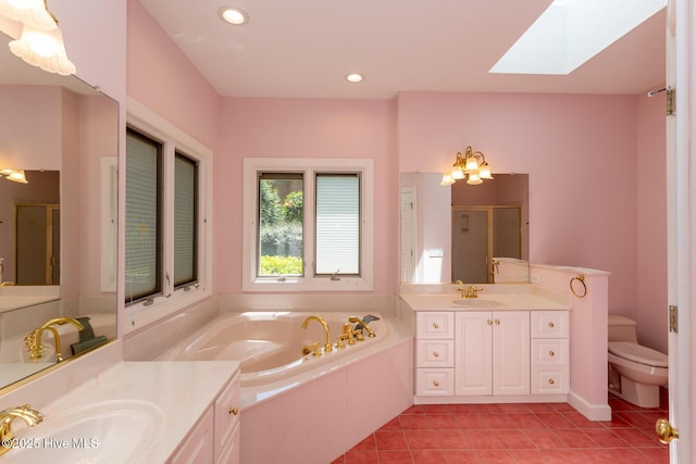 full bathroom featuring a sink, a stall shower, tile patterned floors, and a skylight