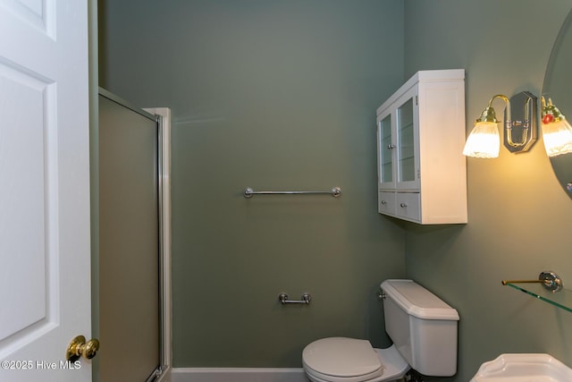 full bathroom with a shower with door and toilet