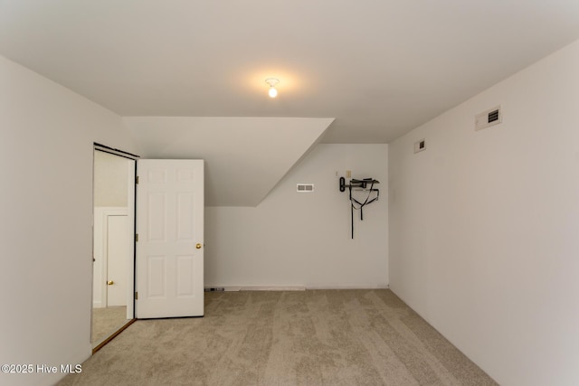 bonus room with visible vents, lofted ceiling, and light colored carpet