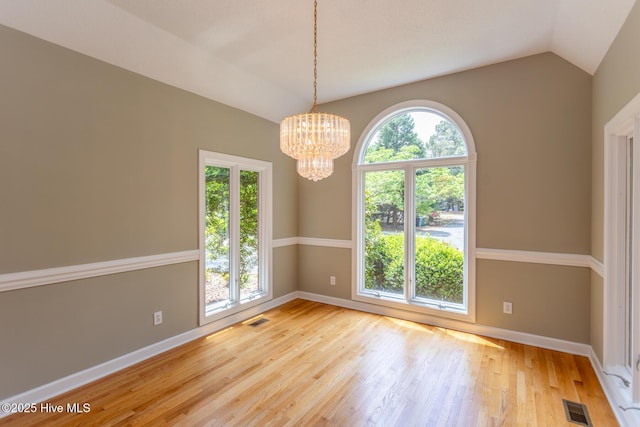 unfurnished dining area featuring baseboards, visible vents, and light wood-style flooring
