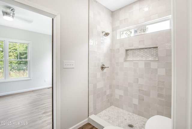 401 Singletary St SE, Wilson, NC 27893 - full bath featuring tiled shower, toilet, baseboards, and wood finished floors