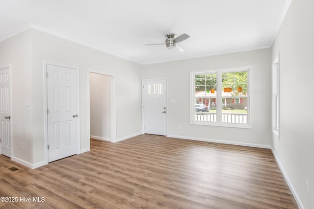 401 Singletary St SE, Wilson, NC 27893 - foyer entrance with a ceiling fan, wood finished floors, crown molding, and baseboards