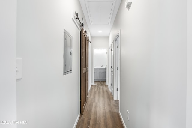401 Singletary St SE, Wilson, NC 27893 - corridor featuring wood finished floors, baseboards, attic access, and a barn door
