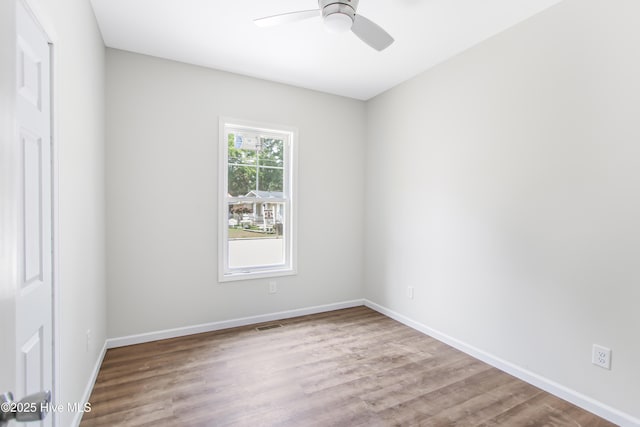 401 Singletary St SE, Wilson, NC 27893 - unfurnished room featuring a ceiling fan, wood finished floors, and baseboards