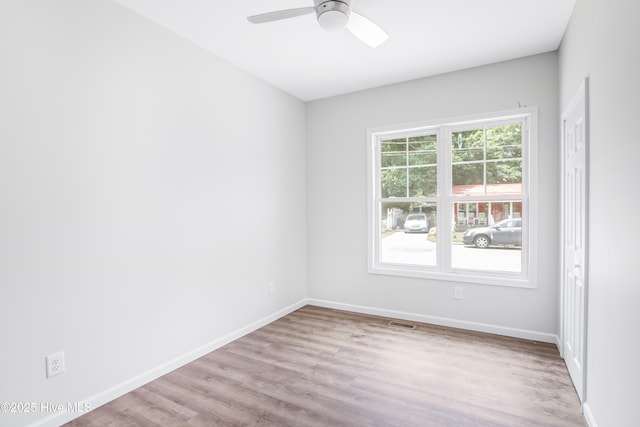 401 Singletary St SE, Wilson, NC 27893 - unfurnished room with a ceiling fan, wood finished floors, and baseboards