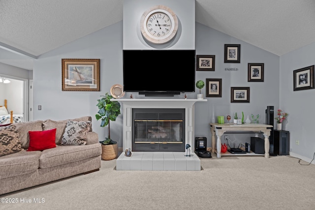 living room with carpet floors, a textured ceiling, vaulted ceiling, and a fireplace
