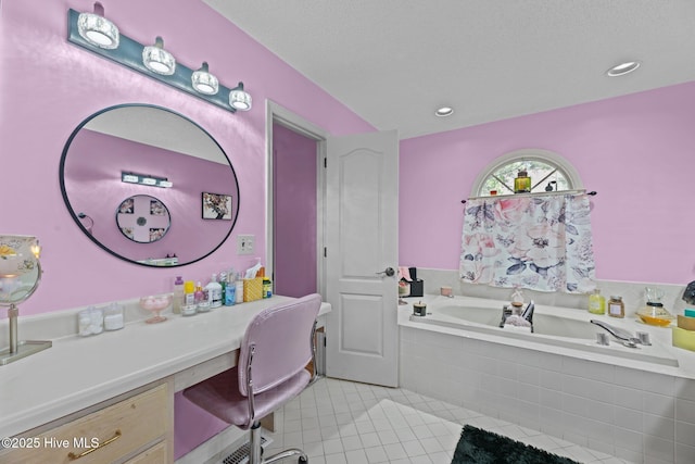 bathroom featuring vanity, tile patterned flooring, and a garden tub