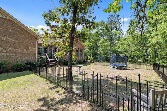 view of yard featuring a fenced backyard and a trampoline