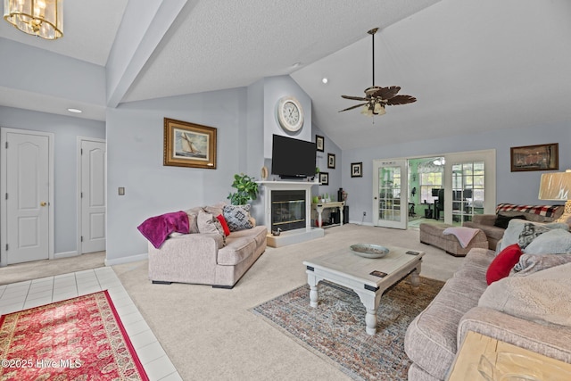 living room with high vaulted ceiling, light colored carpet, baseboards, and ceiling fan with notable chandelier