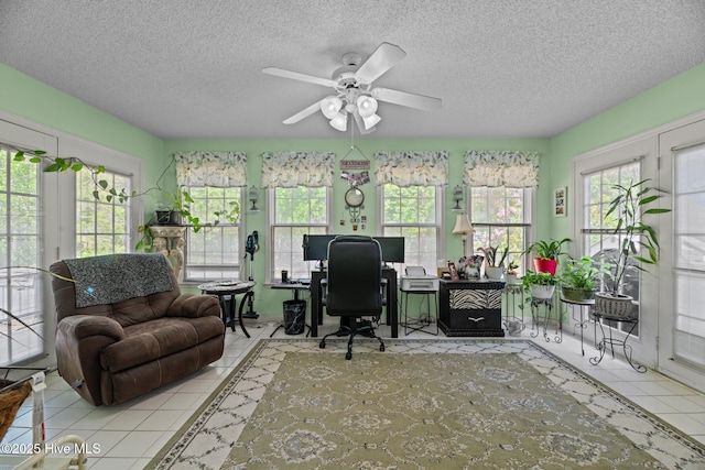 office area featuring a textured ceiling, tile patterned floors, and a wealth of natural light