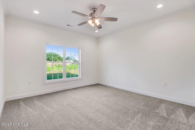 carpeted spare room with baseboards, visible vents, and ornamental molding