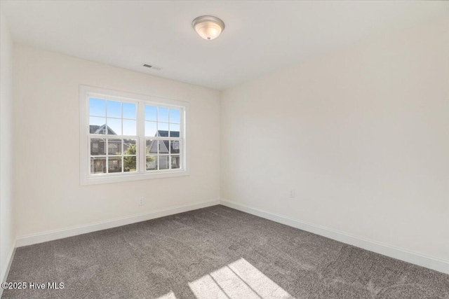 carpeted empty room with baseboards and visible vents