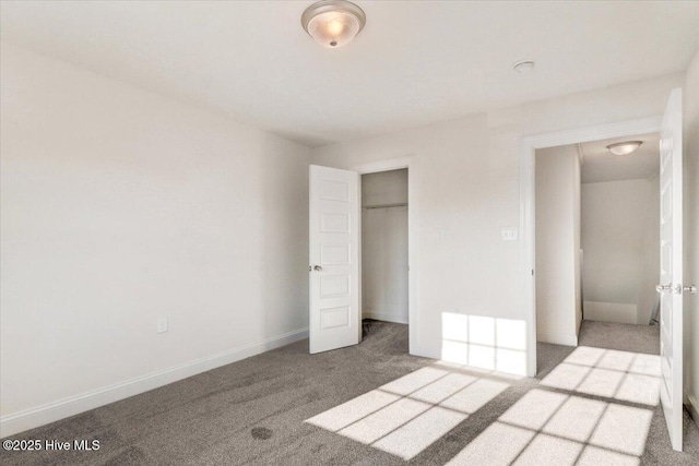 unfurnished bedroom with carpet floors, baseboards, and a closet