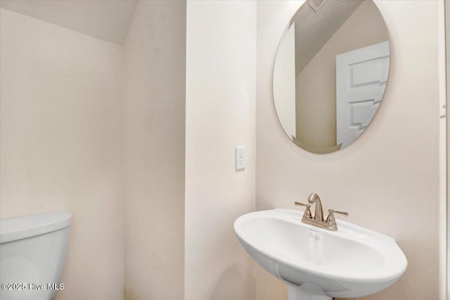 bathroom with toilet and a sink