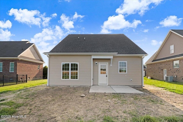 back of property featuring a patio, central AC, and a yard