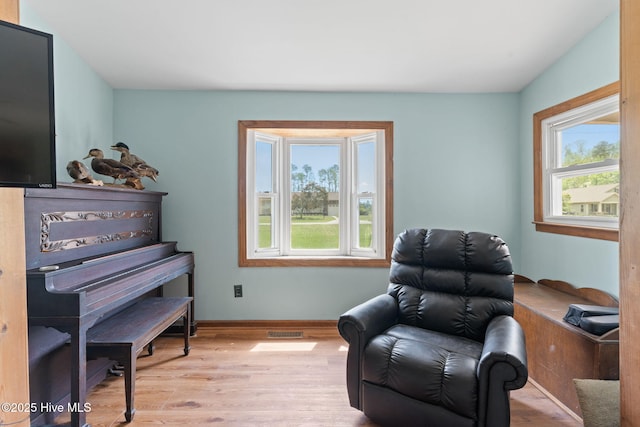sitting room featuring baseboards, wood finished floors, and visible vents