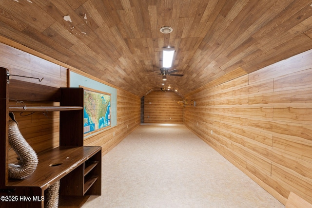 additional living space featuring a ceiling fan, wooden ceiling, lofted ceiling, wooden walls, and carpet flooring
