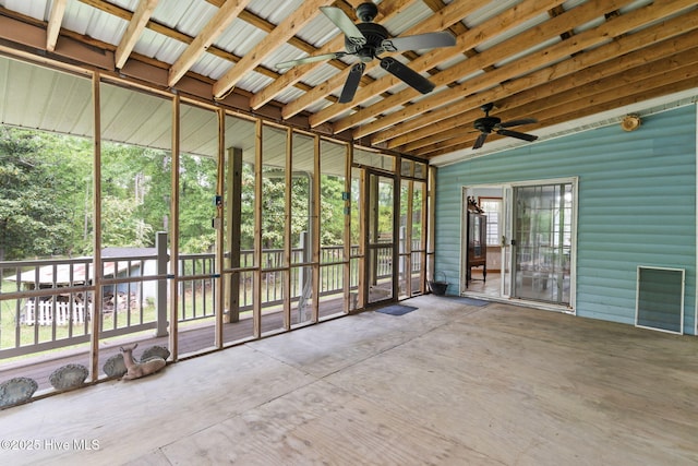unfurnished sunroom featuring ceiling fan