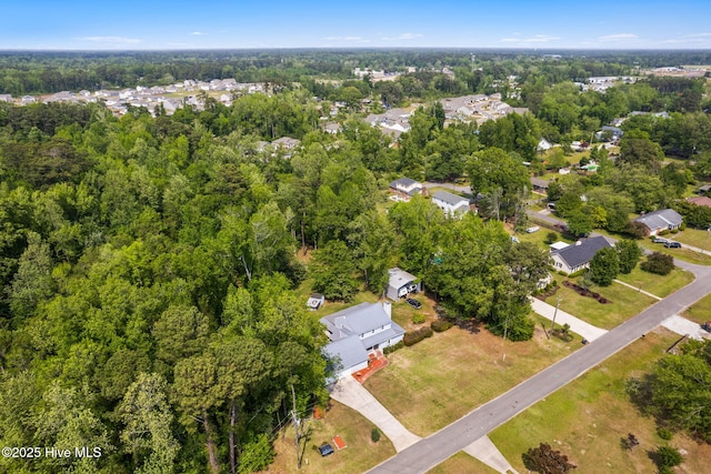 birds eye view of property with a view of trees and a residential view