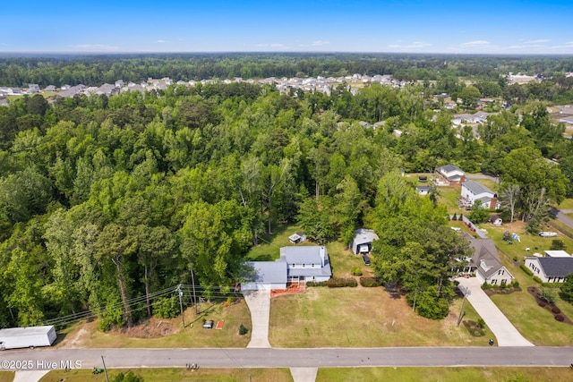 bird's eye view featuring a view of trees and a residential view