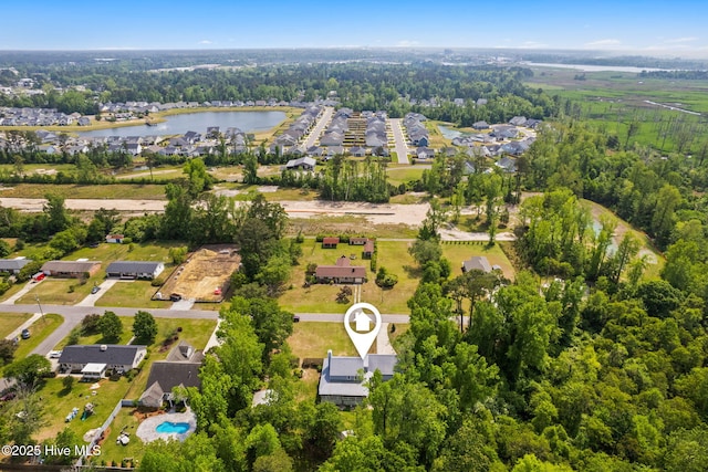 drone / aerial view with a water view and a residential view