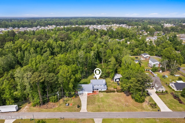 aerial view with a residential view and a wooded view