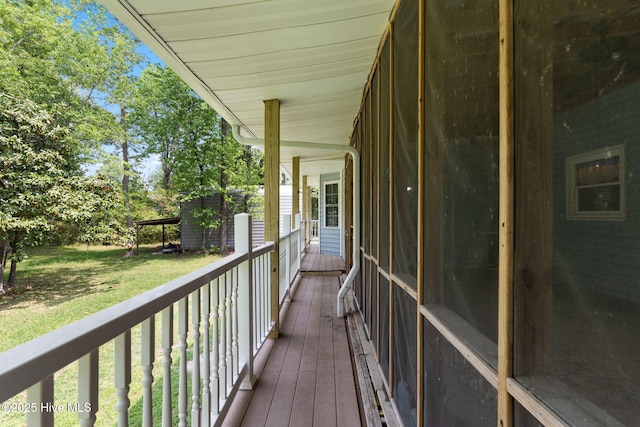deck featuring a lawn and covered porch