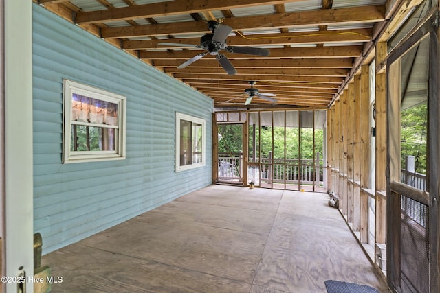 unfurnished sunroom with ceiling fan and a wealth of natural light