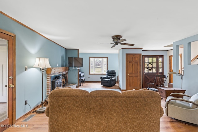 living room featuring baseboards, plenty of natural light, and light wood finished floors