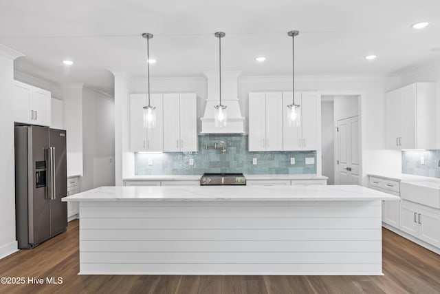 kitchen featuring crown molding, a kitchen island, tasteful backsplash, and stainless steel appliances